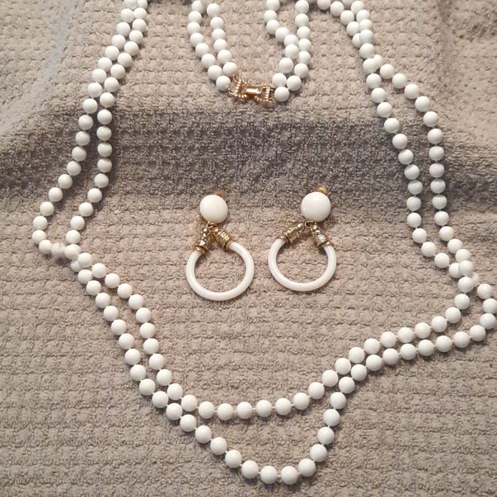 Womens long double strand of beads and earrings.